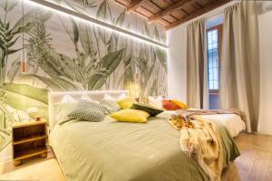 1 dormitorio con 1 cama con almohadas verdes y amarillas en Near the Duomo, Mini Suite Navigli, en Milán
