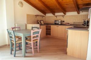 a kitchen with a table and chairs in a room at Larius Apartment - Como Lake View - Free Parking in Mandello del Lario