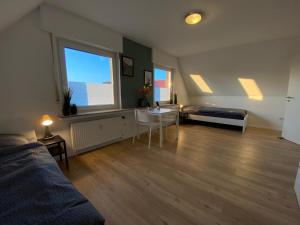 a large living room with a bed and a table at Monteurzimmer Deluxe in Ibbenbüren