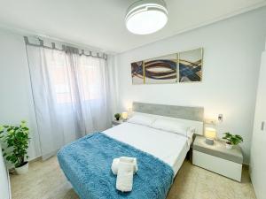 a bedroom with a large bed with a blue blanket at Buenos Aires del Pilar Turistea in Utebo
