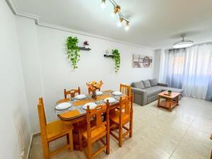 a living room with a table and chairs and a couch at Buenos Aires del Pilar Turistea in Utebo