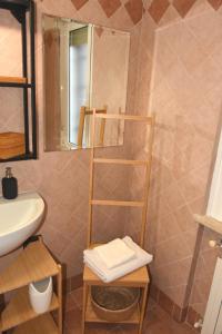 a bathroom with a sink and a towel rack at Cerveteri Loft sea&pool in Cerveteri