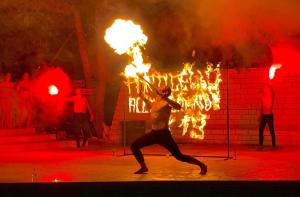 a man is dancing on a stage with fire at Residence Porticello in Vieste