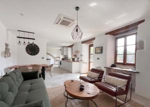 a living room with a couch and a table at Historic Wine-Stone House in Vipava
