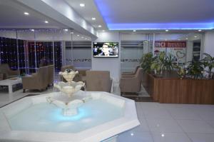 a lobby with a table and chairs and a tv at AGZ Hotel in Dikili