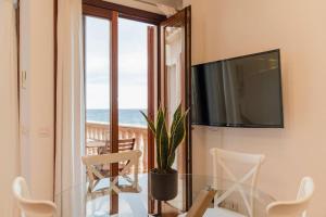 a living room with a glass table and a television at Casa Villa Mar - Port de Valldemossa in Valldemossa