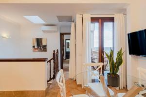 a dining room with a glass table and a view of the ocean at Casa Villa Mar in Valldemossa
