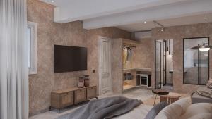 a living room with a television on a wall at F Fine Suites - Adults Only in Lindos