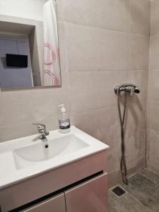 a bathroom with a sink and a shower at Hospedaria Pôr do Sol in Funchal +57 photos