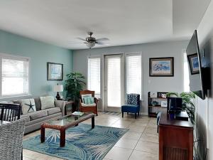 a living room with a couch and a table at Casa Palmera in Port Aransas