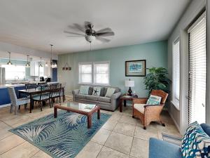 a living room with a couch and a table at Casa Palmera in Port Aransas
