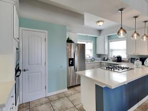 a kitchen with white cabinets and a white counter top at Casa Palmera in Port Aransas