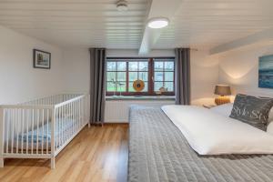 Postel nebo postele na pokoji v ubytování Neukoog Deichzeit