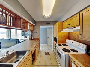 a kitchen with a sink and a stove at Coastal Cozy and a View in Padre Island