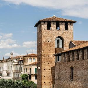 a tall brick building with a bell tower at Valpolicella Lodge parking gratuito fino a 4 pax in SantʼAmbrogio di Valpolicella