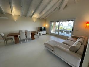 a living room with a couch and a table at Villa Supramonte luxury villa CIN IT09006CR in Marazzino