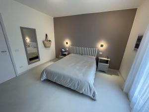 a bedroom with a bed in a white room at Villa Supramonte luxury villa CIN IT09006CR in Marazzino +43 photos