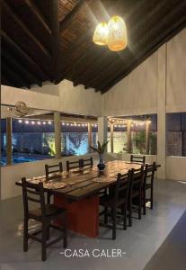 a dining room with a large wooden table and chairs at casa caler in Utica +16 photos