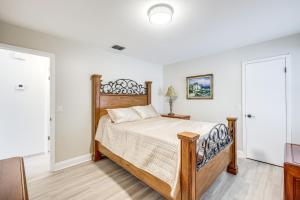 a bedroom with a bed with a wooden headboard at Home with Pool 5 Mi to Neptune Beach in Jacksonville in Jacksonville +19 photos