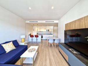a living room with a blue couch and a table at SR Wellingtonia Estepona Centro in Estepona