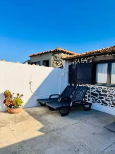 two lounge chairs sitting in front of a building at Casa do Mar | Sea House | Apúlia in Apúlia