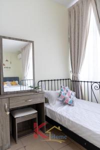 a bedroom with a mirror and a bed and a desk at K Home - Cozy 3-Storey Landed 5R4B-16 Pax- 5mins City Centre & IMAGOMALL in Kota Kinabalu