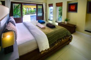 a bedroom with a large bed in a room with windows at Palm View Villa in Lamai +43 photos