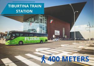 a green bus is parked in front of a building at Il Magnifico Superior Rooms 400m from Tiburtina Railway Station and 290m from Metro in Rome
