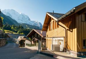 a group of buildings with a mountain in the background at Chalet Sterndolde Apt 1 in Wengen