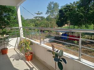 a balcony with a view of a train on the tracks at Luxury Bonafide Villa in Lohārghāt