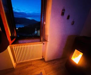 a room with a window with a candle in front of it at La Dimora del Turano in Castel di Tora