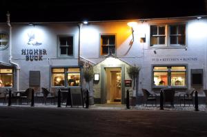 a building with tables and chairs outside of it at night at Higher Buck Inn in Waddington