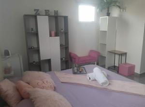 a living room with a couch and a red chair at Love Room Douceur in Tremblay-En-France