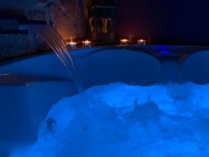 a bath tub with water being poured into it at night at LOFT MORA - BENAOCAZ in Benaocaz
