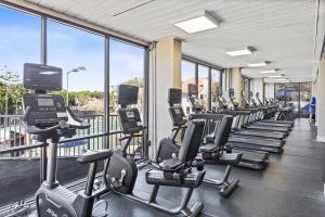 a gym with a row of treadmills and machines at TOPS'L Beach Manor I in Destin