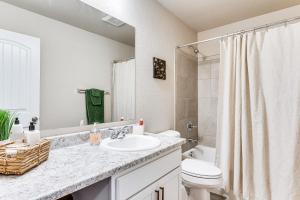 a bathroom with a sink and a toilet at 10 Mi to Fort Carson Newly Built Townhome! in Fountain +19 photos