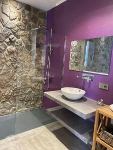 a bathroom with a sink and a glass shower at Loft mora - benaocaz in Benaocaz +2 photos