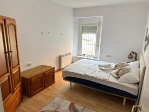 a small bedroom with a bed and a window at Relax Holiday Home in Vallromanas +5 photos