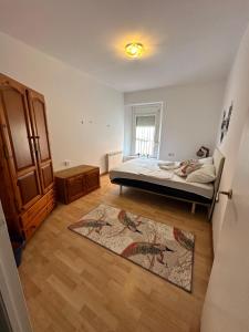 a bedroom with a bed and a rug at Relax Holiday Home in Vallromanas