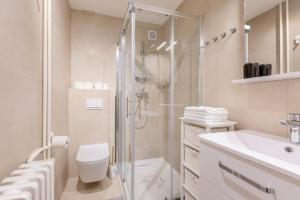 a bathroom with a shower and a toilet and a sink at Bright Urban Cukor Suite - Balcony - Free Parking - Near Arena & Jarun in Zagreb +32 photos