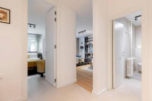 a room with a hallway with a mirror and a bedroom at Bright Urban Cukor Suite - Balcony - Free Parking - Near Arena & Jarun in Zagreb