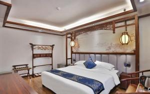 Zhangjiajie Huan Sha Ju Hotel客房内的一张或多张床位
