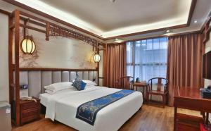 Zhangjiajie Huan Sha Ju Hotel客房内的一张或多张床位