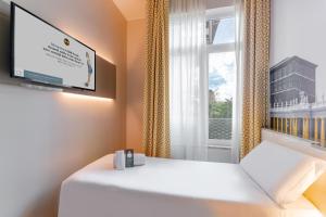 Postel nebo postele na pokoji v ubytování B&B Hotel Roma Pietralata Tiburtina
