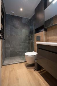 a bathroom with a toilet and a glass shower at GatheringThess- The backyard in Thessaloniki