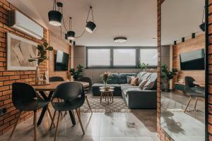 a living room with a couch and a table at Balans nad Jeziorem in Ślesin
