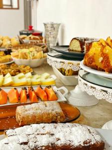 a table topped with lots of different types of food at Hotel Cidade De Bauru in Bauru +10 photos