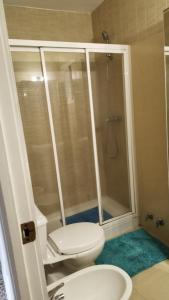 a bathroom with a shower with a toilet and a sink at URBION HOME in Seville