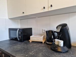 a kitchen counter with a coffee maker and a microwave at Ferienwohnung in Krefeld in Krefeld