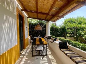 a patio with a table and chairs on a balcony at Casa Justa Panarea Drautto in Panarea